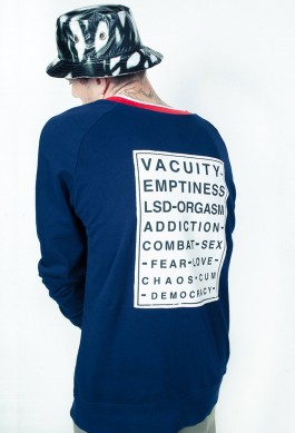 photography. Fashion editorial. model wearing a blue sweat with vision test printed on back. 