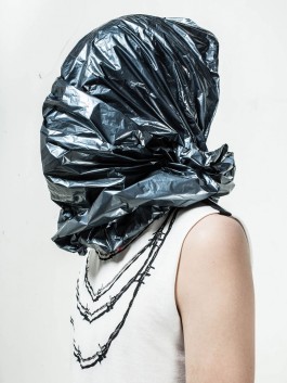 Photography. Fashion editorial. Model with black plastic bag on his head. 