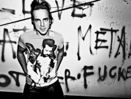 photography. Fashion editorial. Black & white photo. model posing in front of a tagged wall 