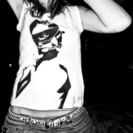 photography. Fashion editorial. Black & white photo of a girl wearing white t-shirt with bdsm print on front 