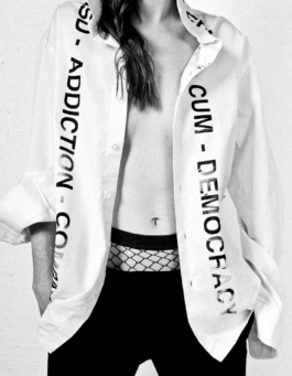 Photography. Fashion editorial. Female model wearing an opened printed shirt. 