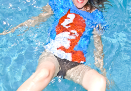 art direction. Photography. Model wearing blue cat woman t-shirt in the swimming pool. 