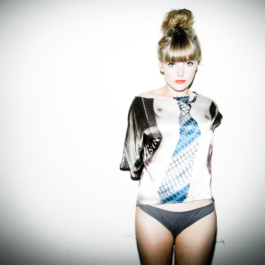 Photography. Fashion editorial. Model wears a printed silk top 